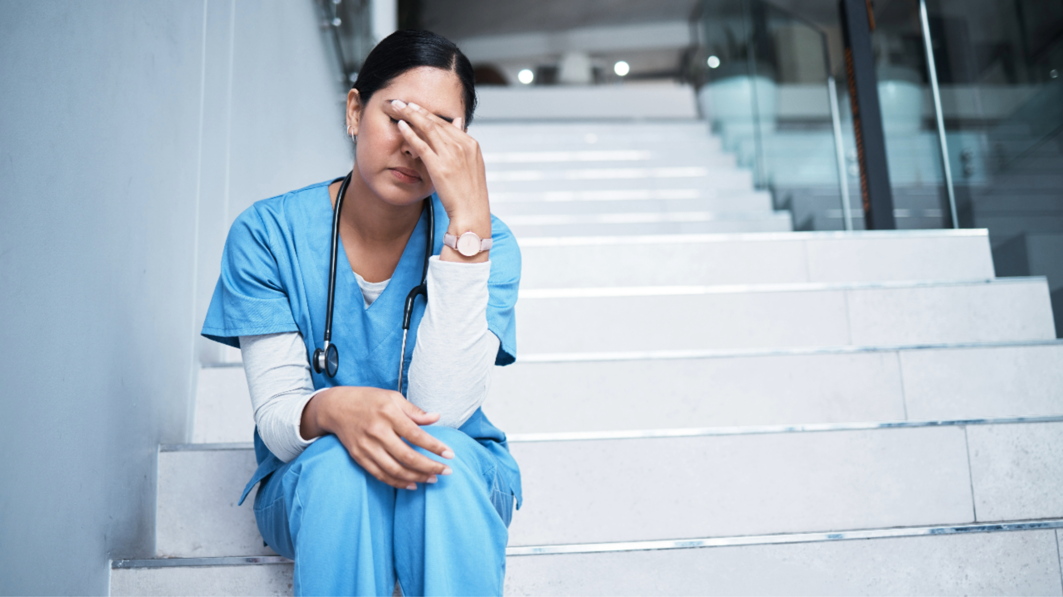 Image: A stressed nurse in a hospital setting, symbolizing workplace incivility and its impact on healthcare professionals.