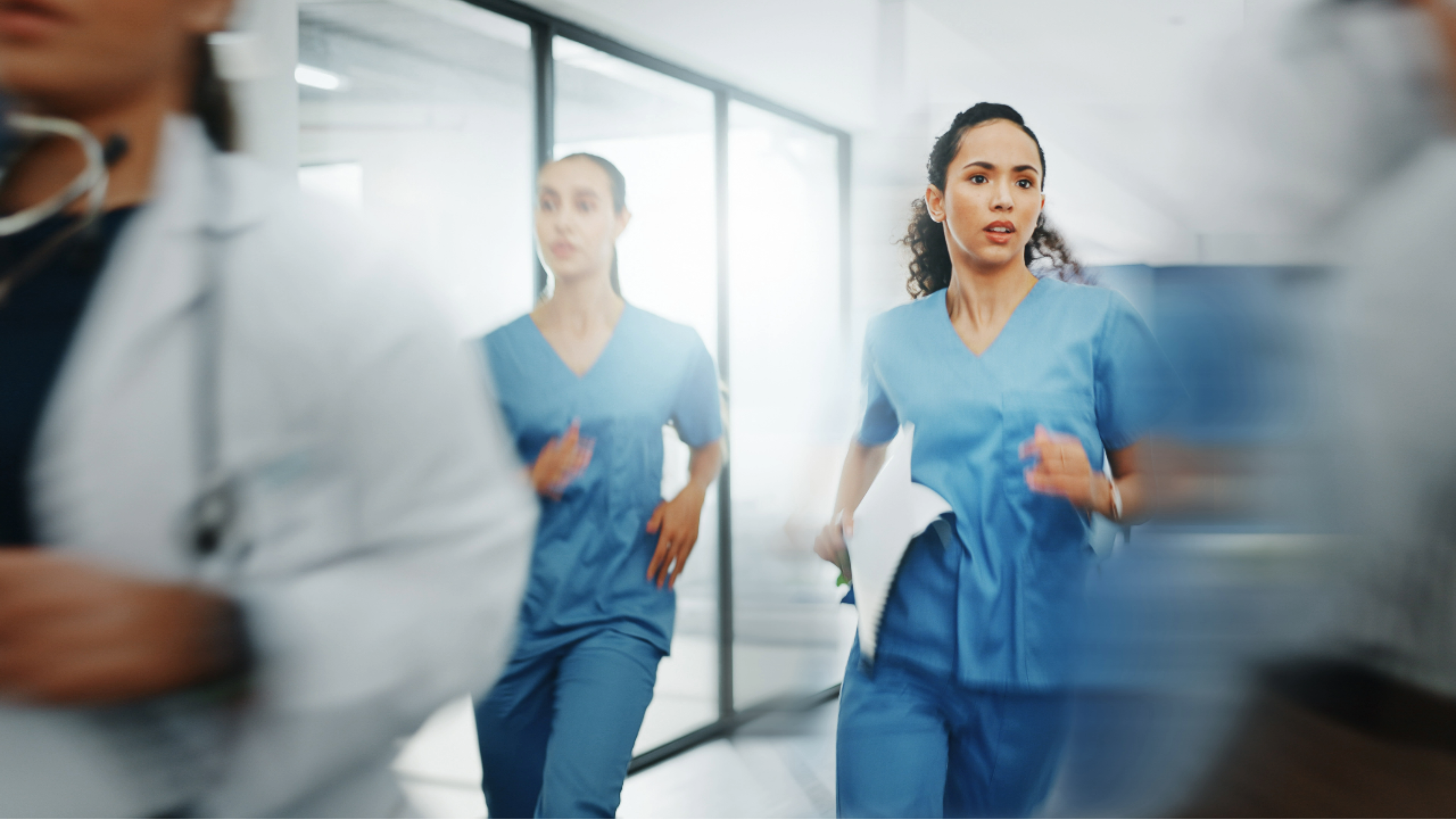 Image: A stressed nurse in a healthcare setting, reflecting the challenges and pressures of the profession.