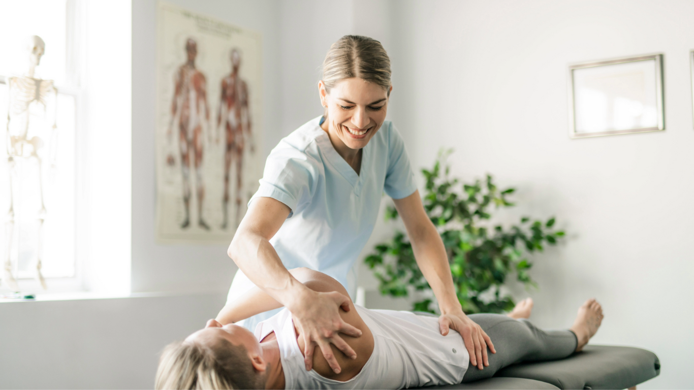 Image: A physical therapist working with a patient, providing one-on-one care and guidance during a rehabilitation session. The therapist is assisting the patient in performing exercises to improve mobility and strength.