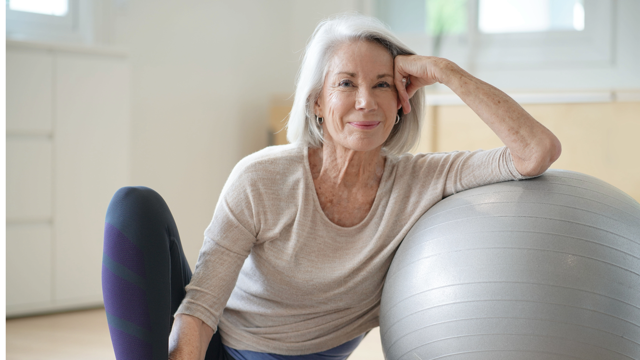 An elderly patient joyfully participates in exercise, highlighting the positive impact of patient engagement in senior care. The image reflects the commitment to physical activity, promoting health and well-being in the older population while fostering a sense of community and camaraderie.